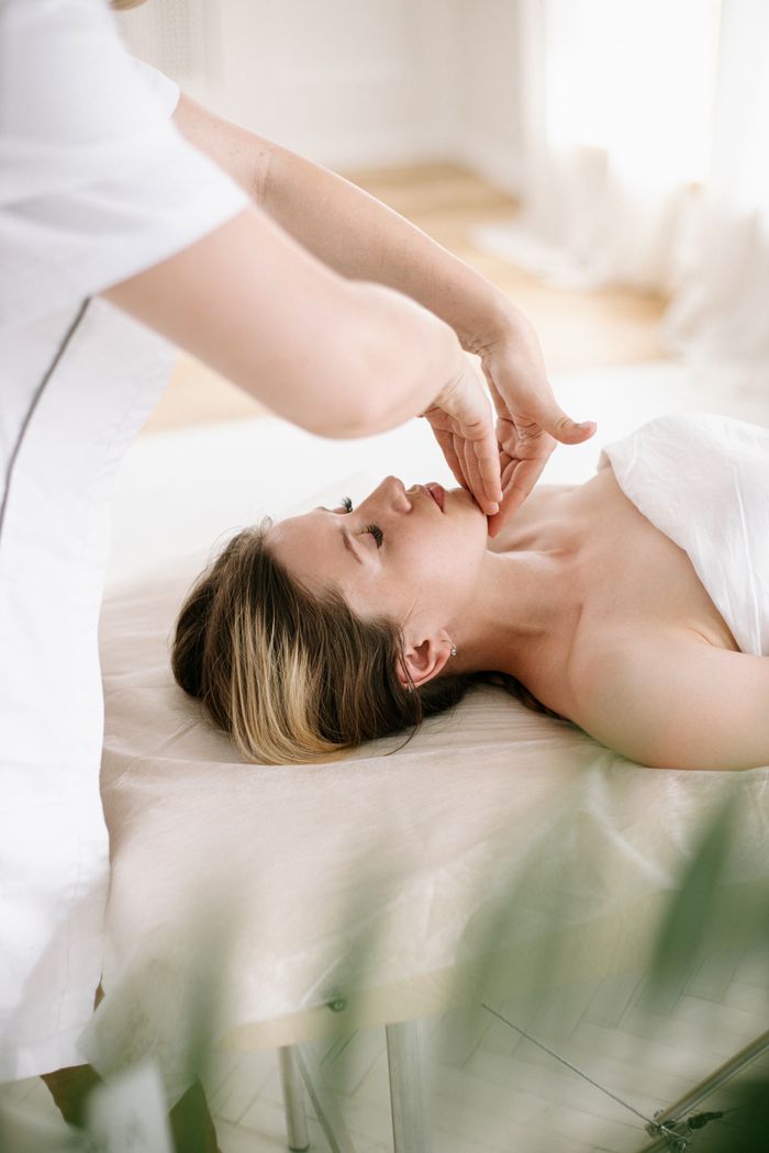 Crafting Captivating Headlines: Your awesome post title goes here Woman enjoys a soothing facial massage in a serene spa environment, promoting relaxation and skincare.
